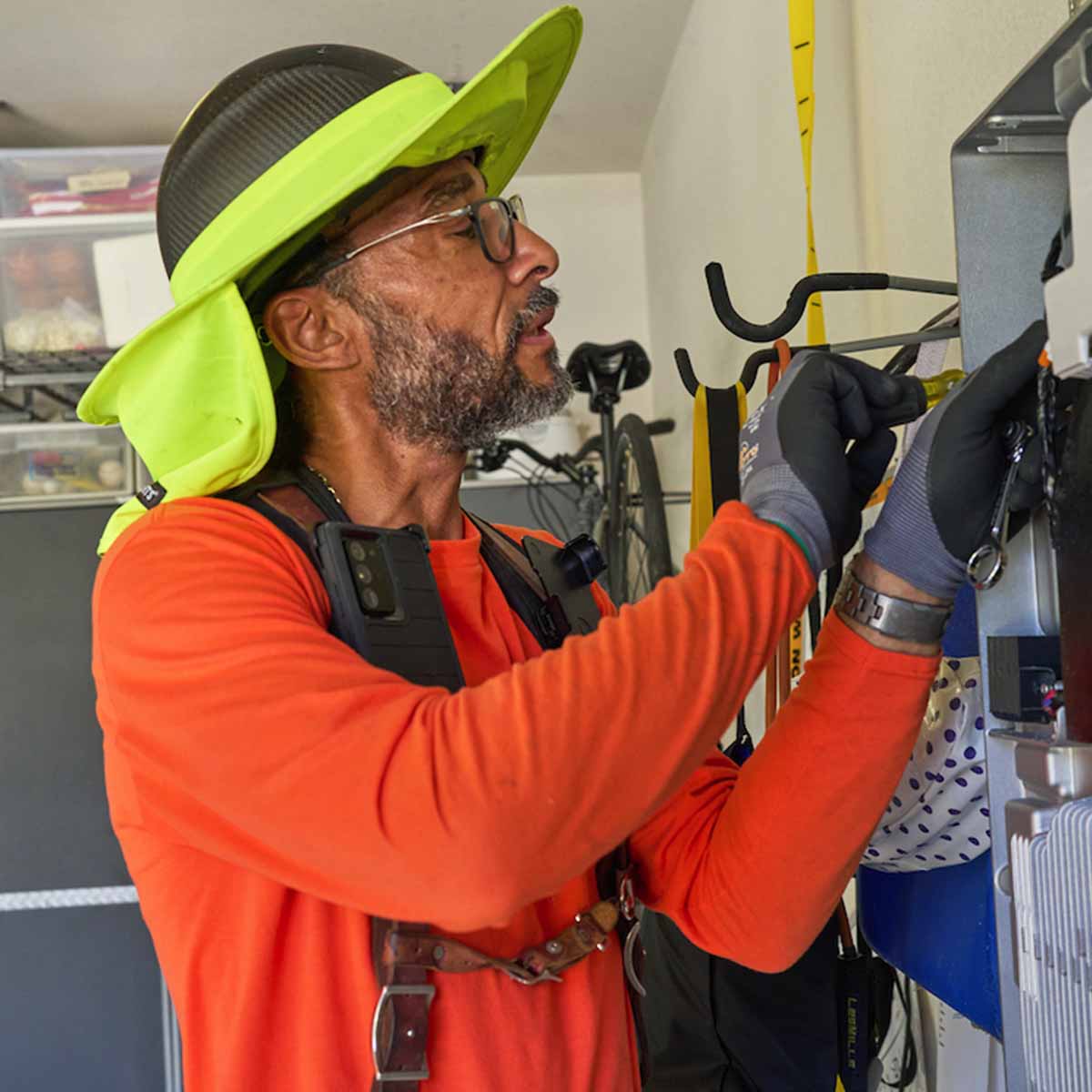 Electrician opening an electric panel.